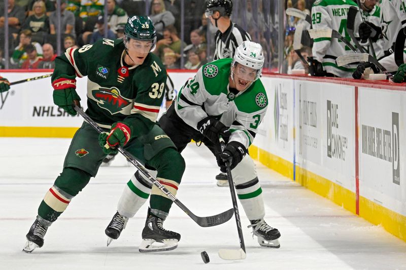 Sep 29, 2024; Saint Paul, Minnesota, USA;  Minnesota Wild forward Ben Jones (39) and Dallas Stars forward Cameron Hughes (34) battle for the puck during the second period at Xcel Energy Center. Mandatory Credit: Nick Wosika-Imagn Images