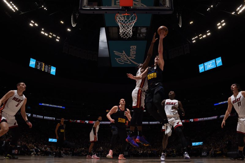 DENVER, CO - FEBRUARY 29: Christian Braun #0 of the Denver Nuggets drives to the basket during the game against the Miami Heat on February 29, 2024 at the Ball Arena in Denver, Colorado. NOTE TO USER: User expressly acknowledges and agrees that, by downloading and/or using this Photograph, user is consenting to the terms and conditions of the Getty Images License Agreement. Mandatory Copyright Notice: Copyright 2024 NBAE (Photo by Garrett Ellwood/NBAE via Getty Images)