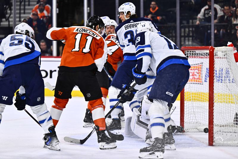 Feb 8, 2024; Philadelphia, Pennsylvania, USA; Philadelphia Flyers right wing Travis Konecny (11) watches as the puck enters the net for a goal against the Winnipeg Jets in the first period at Wells Fargo Center. Mandatory Credit: Kyle Ross-USA TODAY Sports