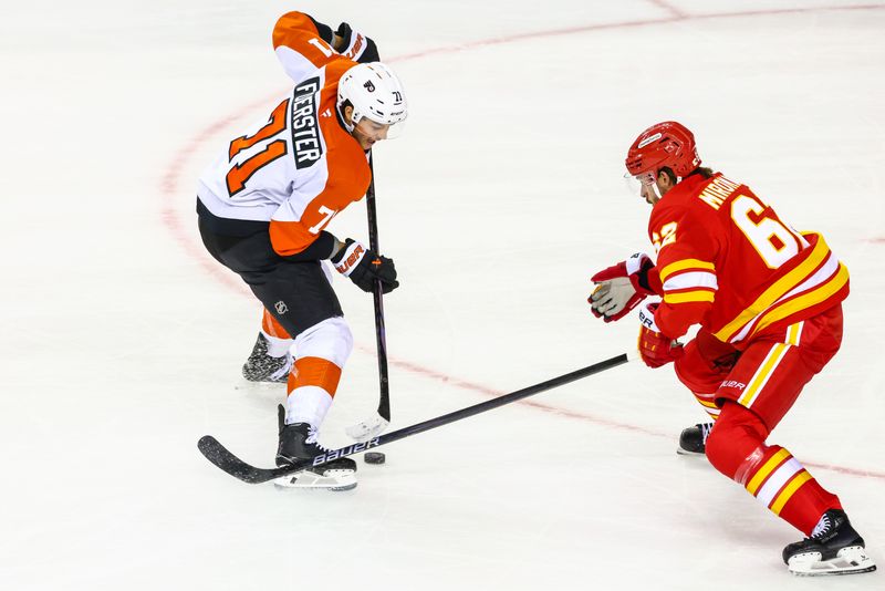 Oct 12, 2024; Calgary, Alberta, CAN; Philadelphia Flyers right wing Tyson Foerster (71) controls the puck against Calgary Flames defenseman Daniil Miromanov (62) during the first period at Scotiabank Saddledome. Mandatory Credit: Sergei Belski-Imagn Images