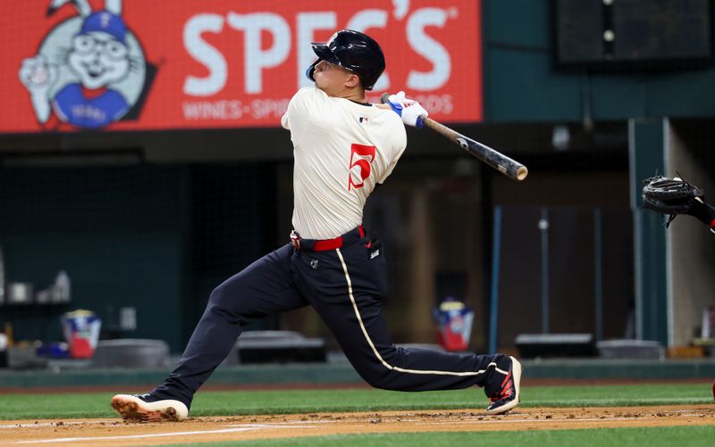 Aug 2, 2024; Arlington, Texas, USA; Texas Rangers shortstop Corey Seager (5) hits a home run during the first inning against the Boston Red Sox at Globe Life Field. Mandatory Credit: Kevin Jairaj-USA TODAY Sports