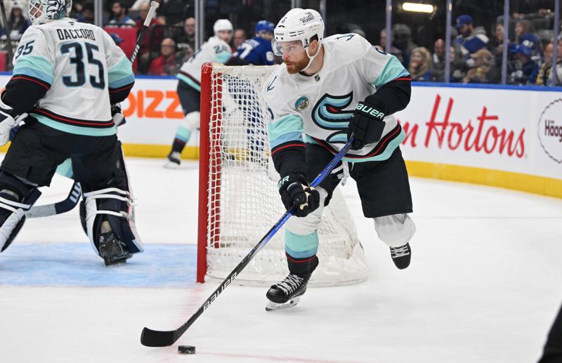 Oct 31, 2024; Toronto, Ontario, CAN;  Seattle Kraken defenseman Adam Larsson (6) skates with the puck against the Toronto Maple Leafs in the first period at Scotiabank Arena. Mandatory Credit: Dan Hamilton-Imagn Images