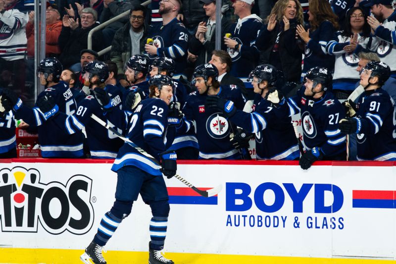 Feb 20, 2024; Winnipeg, Manitoba, CAN; Winnipeg Jets forward Mason Appleton (22) is congratulated by his team mates on his goal against the Minnesota Wild during the first period at Canada Life Centre. Mandatory Credit: Terrence Lee-USA TODAY Sports