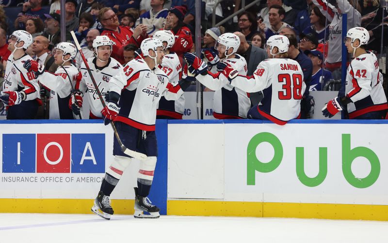 Nov 27, 2024; Tampa, Florida, USA; Washington Capitals right wing Tom Wilson (43) is congratulated after he scored a goal against the Tampa Bay Lightning during the third period at Amalie Arena. Mandatory Credit: Kim Klement Neitzel-Imagn Images