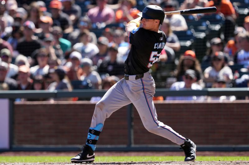 Sep 1, 2024; San Francisco, California, USA; Miami Marlins right fielder Griffin Conine (56) hits an RBI single against the San Francisco Giants during the sixth inning at Oracle Park. Mandatory Credit: Darren Yamashita-USA TODAY Sports