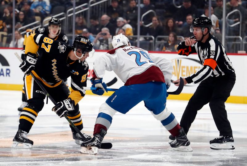 Oct 26, 2023; Pittsburgh, Pennsylvania, USA; Pittsburgh Penguins center Sidney Crosby (87) and Colorado Avalanche center Nathan MacKinnon (29) take the opening face-off during the first period at PPG Paints Arena. Mandatory Credit: Charles LeClaire-USA TODAY Sports