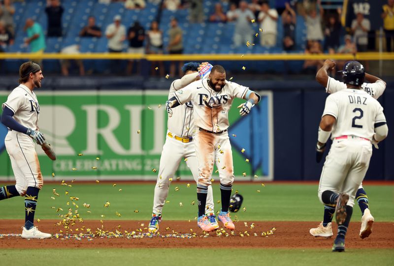 Sep 21, 2023; St. Petersburg, Florida, USA; Tampa Bay Rays center fielder Manuel Margot (13) celebrated by getting gum dumped on him by designated hitter Harold Ramirez (43) after he hit the game winning walk off RBI during the ninth inning against the Los Angeles Angels at Tropicana Field. Mandatory Credit: Kim Klement Neitzel-USA TODAY Sports