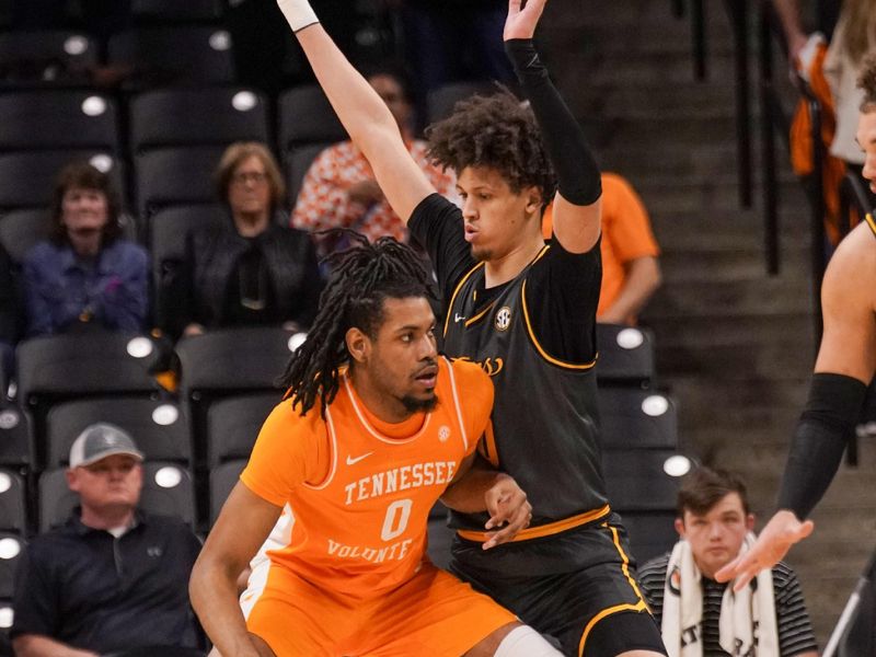 Feb 20, 2024; Columbia, Missouri, USA; Tennessee Volunteers forward Jonas Aidoo (0) dribbles the ball as Missouri Tigers forward Jordan Butler (0) defends during the first half at Mizzou Arena. Mandatory Credit: Denny Medley-USA TODAY Sports