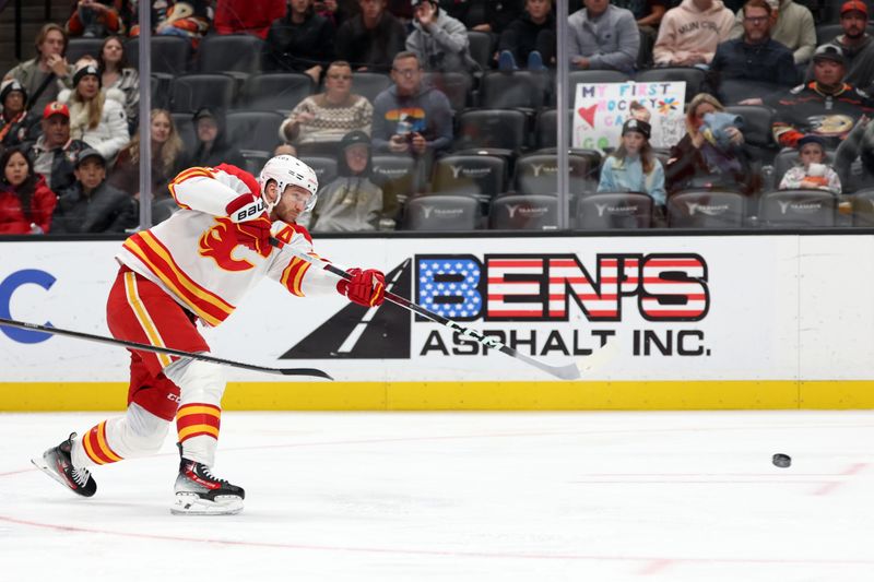 Dec 21, 2023; Anaheim, California, USA;  Calgary Flames center Jonathan Huberdeau (10) shoots the puck during the first period against the Anaheim Ducks at Honda Center. Mandatory Credit: Kiyoshi Mio-USA TODAY Sports