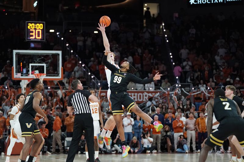 Jan 14, 2026; Austin, Texas, USA; Texas Longhorns center Matas Vokietaitis (8) tips off against Vanderbilt Commodores forward Devin McGlockton (99) during the first half at Moody Center. Mandatory Credit: Dustin Safranek-Imagn Images
