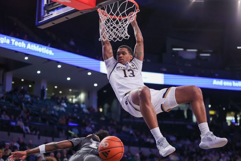 Jan 9, 2024; Atlanta, Georgia, USA; Notre Dame Fighting Irish forward Tae Davis (13) hangs on the rim after a dunk against the Georgia Tech Yellow Jackets in the first half at McCamish Pavilion. Mandatory Credit: Brett Davis-USA TODAY Sports