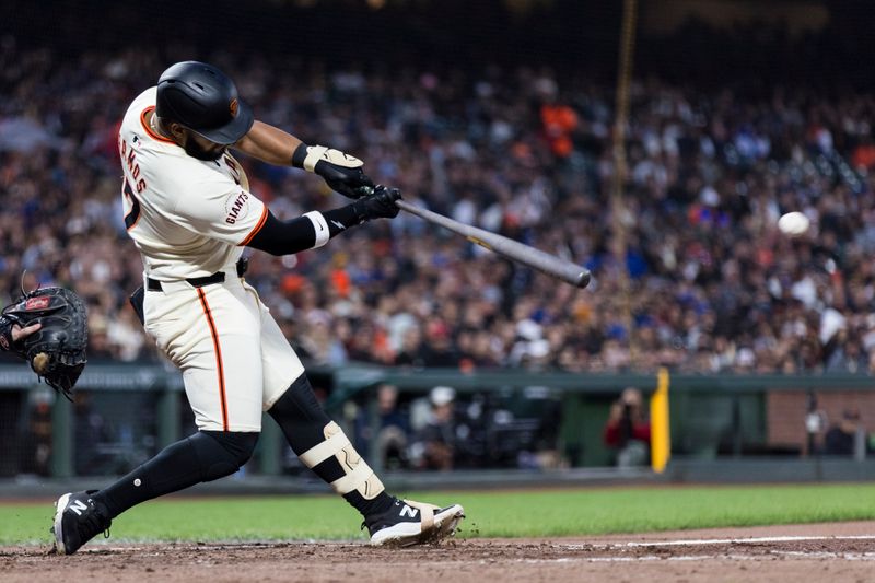 May 15, 2024; San Francisco, California, USA; San Francisco Giants left fielder Heliot Ramos (17) hits an RBI double against the Los Angeles Dodgers during the sixth inning at Oracle Park. Mandatory Credit: John Hefti-USA TODAY Sports