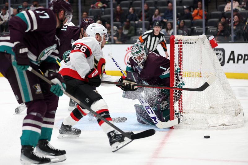 Mar 6, 2024; Anaheim, California, USA;  Anaheim Ducks goaltender Lukas Dostal (1) defends the goal against Ottawa Senators defenseman Erik Brannstrom (26) during the first period at Honda Center. Mandatory Credit: Kiyoshi Mio-USA TODAY Sports