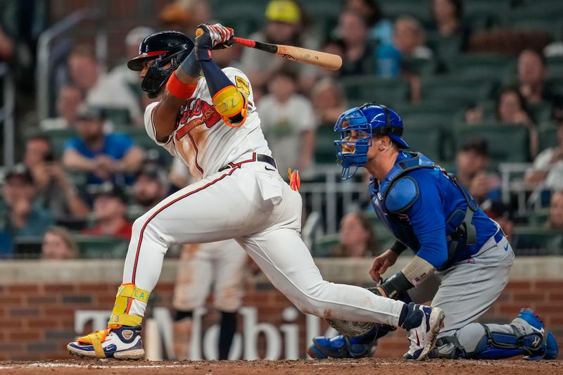 Sep 27, 2023; Cumberland, Georgia, USA; Atlanta Braves right fielder Ronald Acuna Jr. (13) hits a single against the Chicago Cubs during the tenth inning at Truist Park. Mandatory Credit: Dale Zanine-USA TODAY Sports