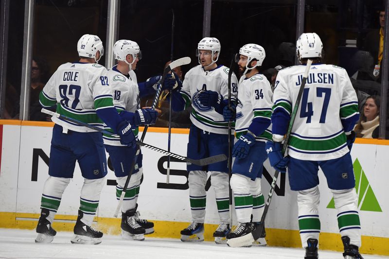 Dec 19, 2023; Nashville, Tennessee, USA; Vancouver Canucks center Nils Aman (88) celebrates with teammates after a goal during the first period against the Nashville Predators at Bridgestone Arena. Mandatory Credit: Christopher Hanewinckel-USA TODAY Sports