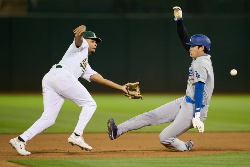 Aug 3, 2024; Oakland, California, USA; Los Angeles Dodgers designated hitter Shohei Ohtani (17) steals second base against Oakland Athletics infielder Darell Hernaiz (2) during the ninth inning at Oakland-Alameda County Coliseum. Mandatory Credit: Robert Edwards-USA TODAY Sports