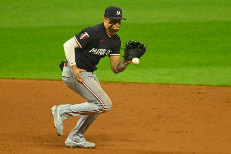 Sep 17, 2024; Cleveland, Ohio, USA; Minnesota Twins third baseman Royce Lewis (23) fields a ground ball in the fifth inning against the Cleveland Guardians at Progressive Field. Mandatory Credit: David Richard-Imagn Images