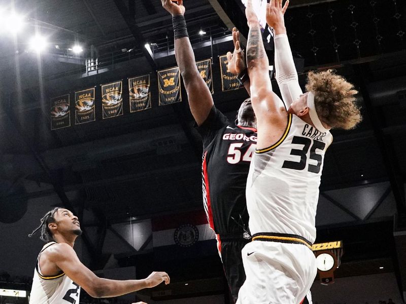 Jan 6, 2024; Columbia, Missouri, USA; Georgia Bulldogs center Russel Tchewa (54) shoots as Missouri Tigers forward Noah Carter (35) defends during the first half at Mizzou Arena. Mandatory Credit: Denny Medley-USA TODAY Sports