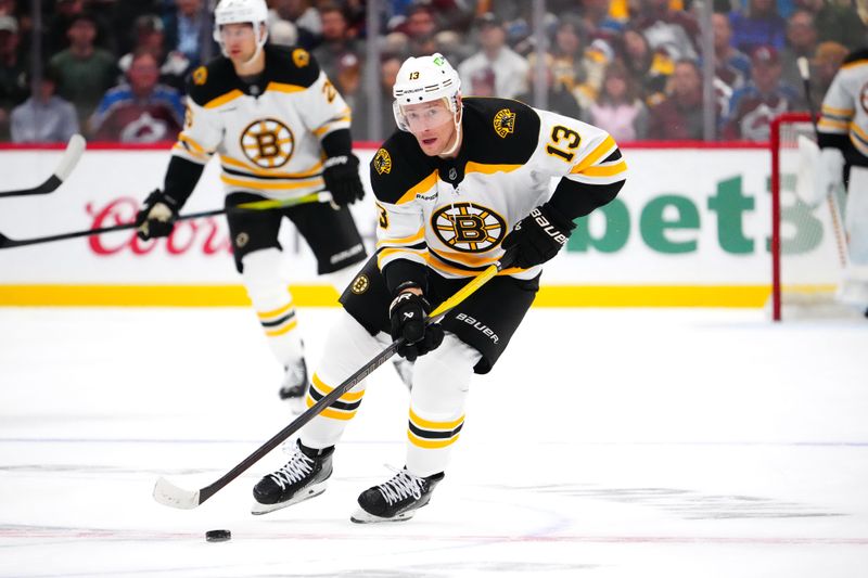 Oct 16, 2024; Denver, Colorado, USA; Boston Bruins center Charlie Coyle (13) controls the puck in the first period against the Colorado Avalanche at Ball Arena. Mandatory Credit: Ron Chenoy-Imagn Images