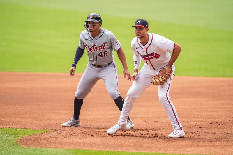 Jun 19, 2024; Cumberland, Georgia, USA; Detroit Tigers right fielder Wenceel Perez (46) leads off of first base behind Atlanta Braves first baseman Matt Olson (28) during the first inning  at Truist Park. Mandatory Credit: Dale Zanine-USA TODAY Sports