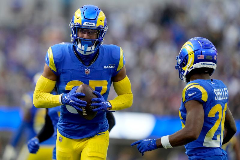 Los Angeles Rams safety Quentin Lake (37), left, recovers a fumble during the second half of an NFL football game against the Arizona Cardinals Sunday, Oct. 15, 2023, in Inglewood, Calif. (AP Photo/Ashley Landis)