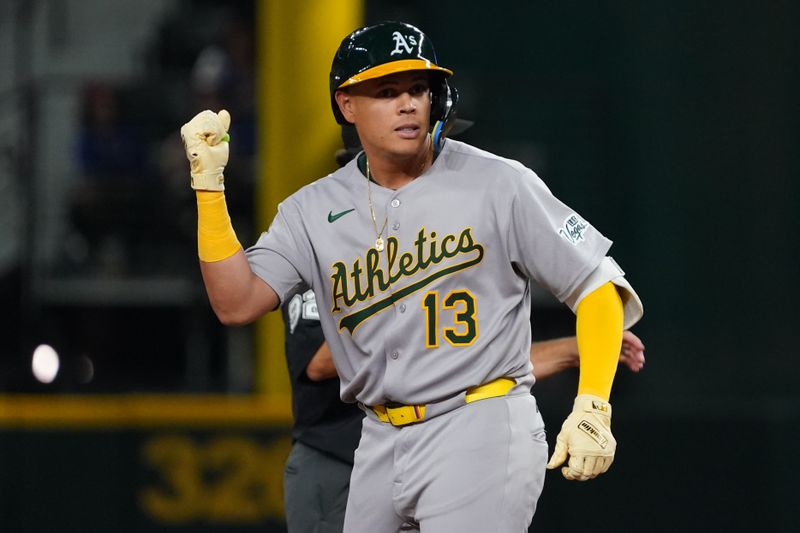Apr 28, 2025; Arlington, Texas, USA; Athletics third baseman Gio Urshela (13) reacts towards the dugout after hitting a double against the Texas Rangers during the fifth inning at Globe Life Field. Mandatory Credit: Raymond Carlin III-Imagn Images