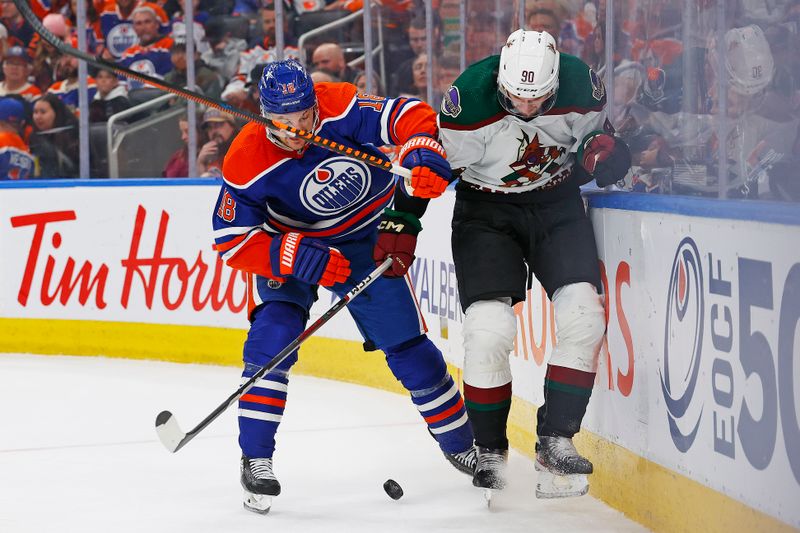 Apr 12, 2024; Edmonton, Alberta, CAN; Edmonton Oilers forward Zach Hyman (18) and Arizona Coyotes defensemen J.J. Moser (90) Battle along the boards for a loose puck during the third period at Rogers Place. Mandatory Credit: Perry Nelson-USA TODAY Sports