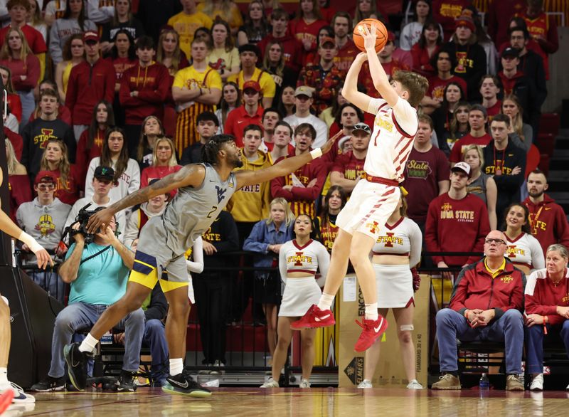 Feb 24, 2024; Ames, Iowa, USA; Iowa State Cyclones guard Jackson Paveletzke (1) shoots over West Virginia Mountaineers guard Kobe Johnson (2) during the second half at James H. Hilton Coliseum. Mandatory Credit: Reese Strickland-USA TODAY Sports