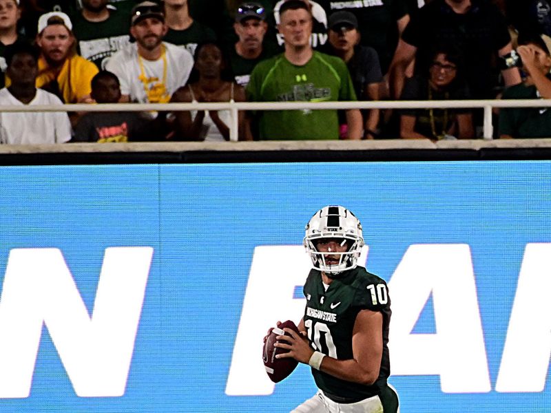 Sep 2, 2022; East Lansing, Michigan, USA; Michigan State Spartans quarterback Payton Thorne (10) sprints for a first down in the fourth quarter at Spartan Stadium during their game against Western Michigan University. Mandatory Credit: Dale Young-USA TODAY Sports
