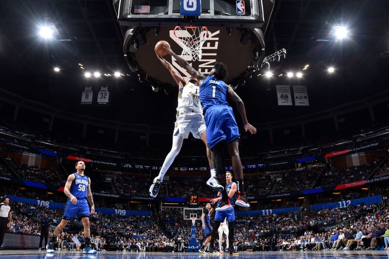 ORLANDO, FL - MARCH 10: Jonathan Isaac #1 of the Orlando Magic blocks shots during the game on March 10, 2024 at Amway Center in Orlando, Florida. NOTE TO USER: User expressly acknowledges and agrees that, by downloading and or using this photograph, User is consenting to the terms and conditions of the Getty Images License Agreement. Mandatory Copyright Notice: Copyright 2024 NBAE (Photo by Fernando Medina/NBAE via Getty Images)