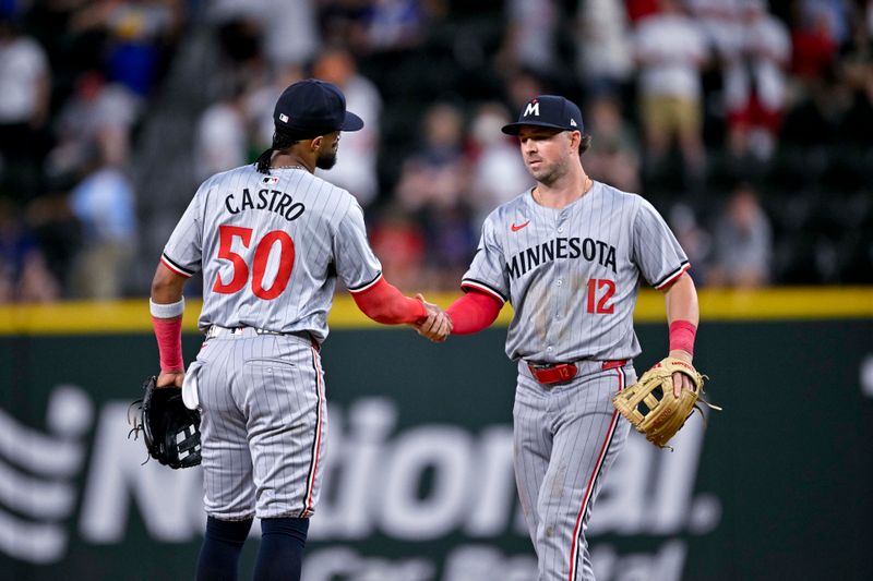 Aug 15, 2024; Arlington, Texas, USA; Minnesota Twins shortstop Willi Castro (50) and second baseman Kyle Farmer (12) celebrate the win over the Texas Rangers at Globe Life Field. Mandatory Credit: Jerome Miron-USA TODAY Sports