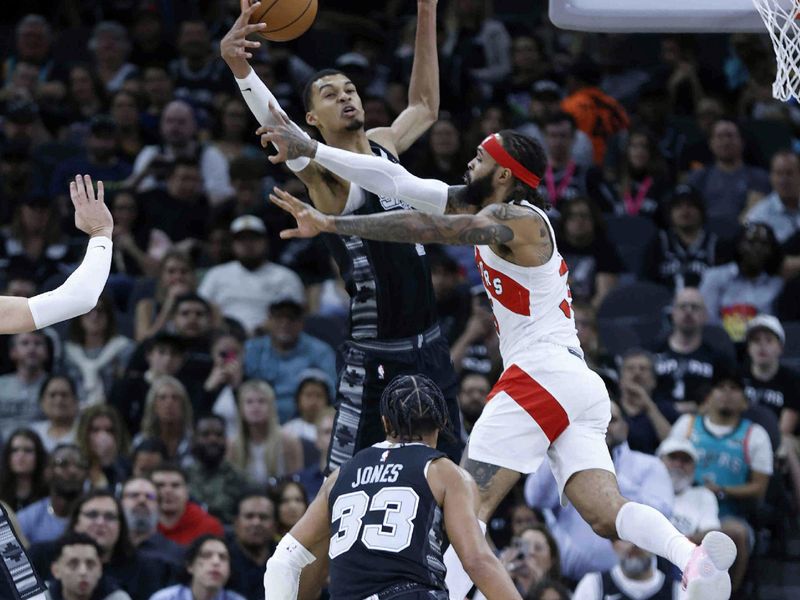 SAN ANTONIO, TX - NOVEMBER 5:  Victor Wembanyama #1 of the San Antonio Spurs blocks shot of Gary Trent Jr. #33 of the Toronto Raptors in the first half at Frost Bank Center on November  5, 2023 in San Antonio, Texas. NOTE TO USER: User expressly acknowledges and agrees that, by downloading and or using this photograph, User is consenting to terms and conditions of the Getty Images License Agreement. (Photo by Ronald Cortes/Getty Images)