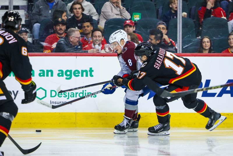 Mar 12, 2024; Calgary, Alberta, CAN; Colorado Avalanche defenseman Cale Makar (8) and Calgary Flames center Yegor Sharangovich (17) battles for the puck during the third period at Scotiabank Saddledome. Mandatory Credit: Sergei Belski-USA TODAY Sports