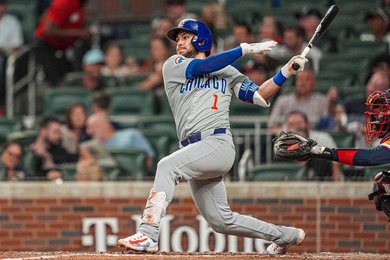 May 14, 2024; Cumberland, Georgia, USA; Chicago Cubs second baseman Nick Madrigal (1) singles against the Atlanta Braves during the seventh inning at Truist Park. Mandatory Credit: Dale Zanine-USA TODAY Sports