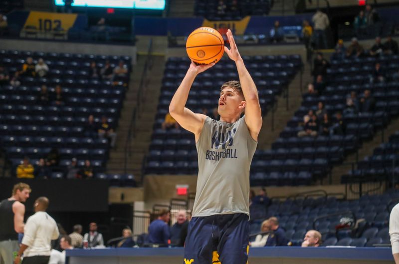 Feb 17, 2024; Morgantown, West Virginia, USA; West Virginia Mountaineers guard Kerr Kriisa (3) warms up prior to their game against the Baylor Bears at WVU Coliseum. Mandatory Credit: Ben Queen-USA TODAY Sports