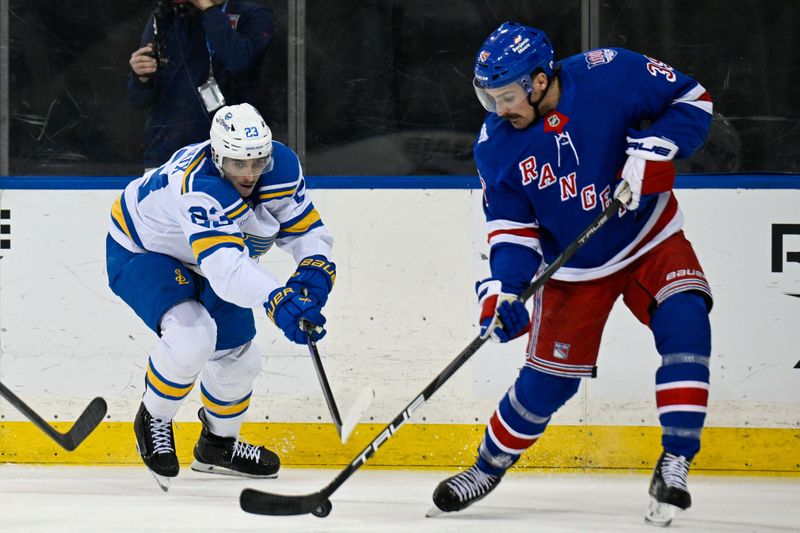 Nov 24, 2025; New York, New York, USA; New York Rangers center Sam Carrick (39) attempts a shot defended by St. Louis Blues defenseman Logan Mailloux (23) during the second period at Madison Square Garden. Mandatory Credit: Dennis Schneidler-Imagn Images