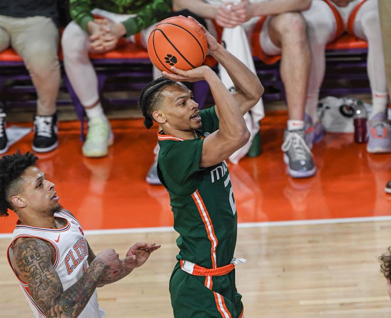 Feb 4, 2023; Clemson, South Carolina, USA;  Miami guard Isaiah Wong (2) shoots near Clemson guard Brevin Galloway (11) during the first half at Littlejohn Coliseum in Clemson, S.C. Saturday, Feb. 4, 2023.  Mandatory Credit: Ken Ruinard-USA TODAY Sports