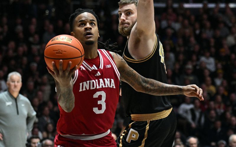 Feb 20, 2026; West Lafayette, Indiana, USA; Indiana Hoosiers guard Lamar Wilkerson (3) shoots against Purdue Boilermakers center Oscar Cluff (45) during the first half at Mackey Arena. Mandatory Credit: Marc Lebryk-Imagn Images
