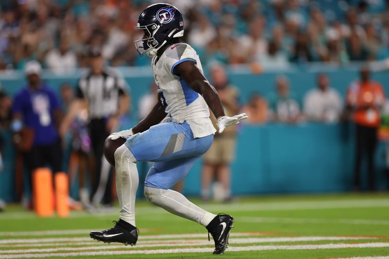 Tennessee Titans running back Tyjae Spears (2) scores a touchdown during the second half of an NFL football game against the Miami Dolphins, Monday, Sept. 30, 2024, in Miami Gardens, Fla. (AP Photo/Brennan Asplen)