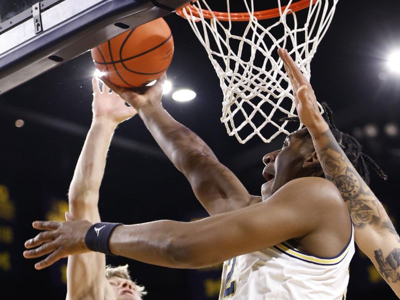 Feb 8, 2023; Ann Arbor, Michigan, USA;  Nebraska Cornhuskers guard Sam Griesel (5) blocks a shot by Michigan Wolverines forward Tarris Reed Jr. (32) in the first half at Crisler Center. Mandatory Credit: Rick Osentoski-USA TODAY Sports