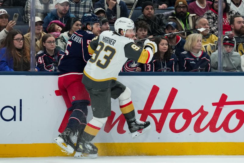 Dec 13, 2025; Columbus, Ohio, USA;  Vegas Golden Knights right wing Mitch Marner (93) checks Columbus Blue Jackets defenseman Denton Mateychuk (5) along the boards in the first period at Nationwide Arena. Mandatory Credit: Aaron Doster-Imagn Images