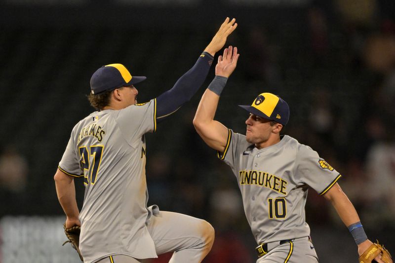 Jun 19, 2024; Anaheim, California, USA; Milwaukee Brewers shortstop Willy Adames (27) and right fielder Sal Frelick (10) celebrate after the final out of the ninth inning defeating the Los Angeles Angels at Angel Stadium. Mandatory Credit: Jayne Kamin-Oncea-USA TODAY Sports