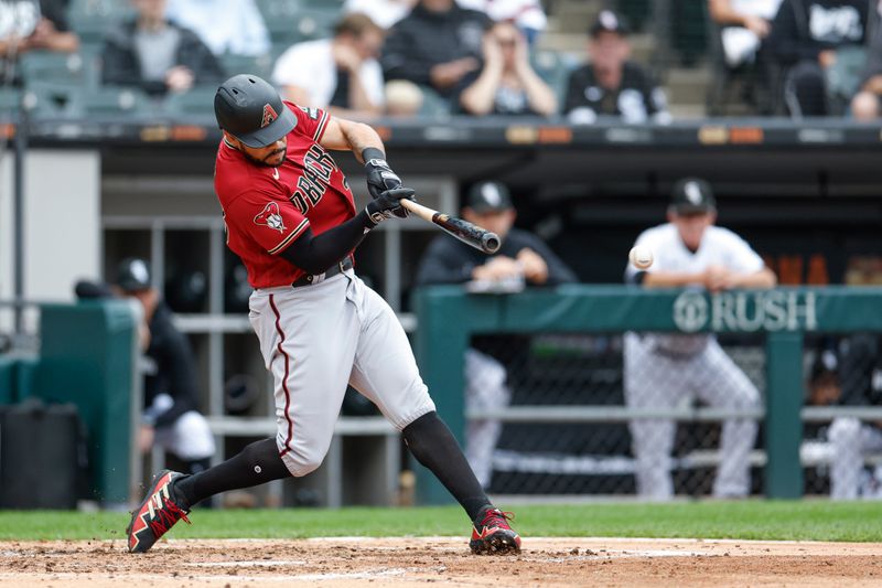 Sep 27, 2023; Chicago, Illinois, USA; Arizona Diamondbacks left fielder Tommy Pham (28) hits an RBI-single against the Chicago White Sox during the third inning at Guaranteed Rate Field. Mandatory Credit: Kamil Krzaczynski-USA TODAY Sports