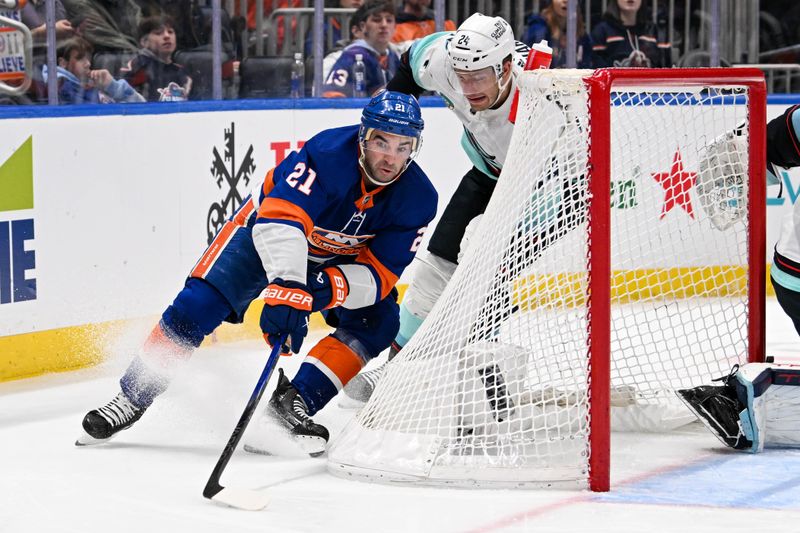 Feb 13, 2024; Elmont, New York, USA; New York Islanders center Kyle Palmieri (21) attempted a wrap a round defended by Seattle Kraken defenseman Jamie Oleksiak (24) during the second period at UBS Arena. Mandatory Credit: Dennis Schneidler-USA TODAY Sports