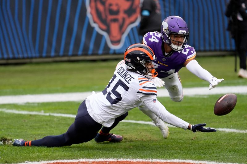 Chicago Bears wide receiver Rome Odunze (15) misses on a touchdown catch attempt as Minnesota Vikings safety Camryn Bynum (24) defends during the second half of an NFL football game Sunday, Nov. 24, 2024, in Chicago. (AP Photo/Charles Rex Arbogast)