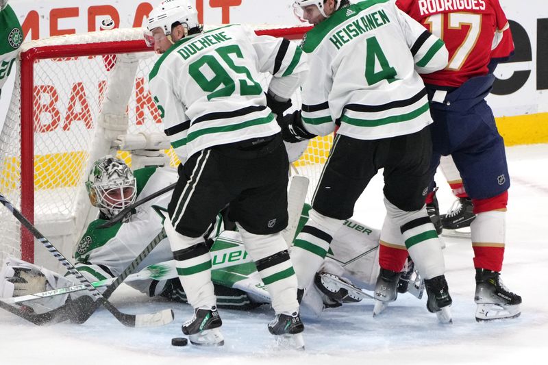 Dec 6, 2023; Sunrise, Florida, USA; Dallas Stars goaltender Jake Oettinger (29) makes a save against the Florida Panthers as center Matt Duchene (95) and defenseman Miro Heiskanen (4) close in during the third period at Amerant Bank Arena. Mandatory Credit: Jim Rassol-USA TODAY Sports