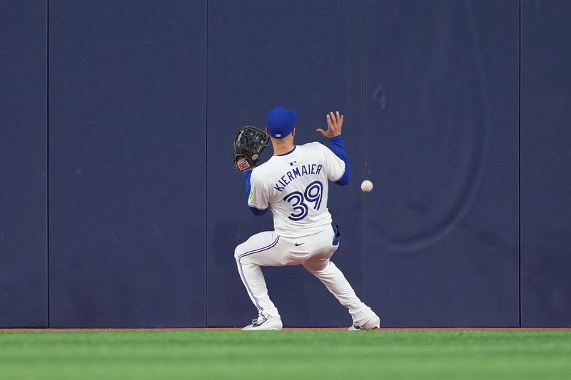 Apr 17, 2024; Toronto, Ontario, CAN; Toronto Blue Jays centre fielder Kevin Kiermaier (39) is unable to catch a fly ball against the New York Yankees during the fifth inning at Rogers Centre. Mandatory Credit: Nick Turchiaro-USA TODAY Sports