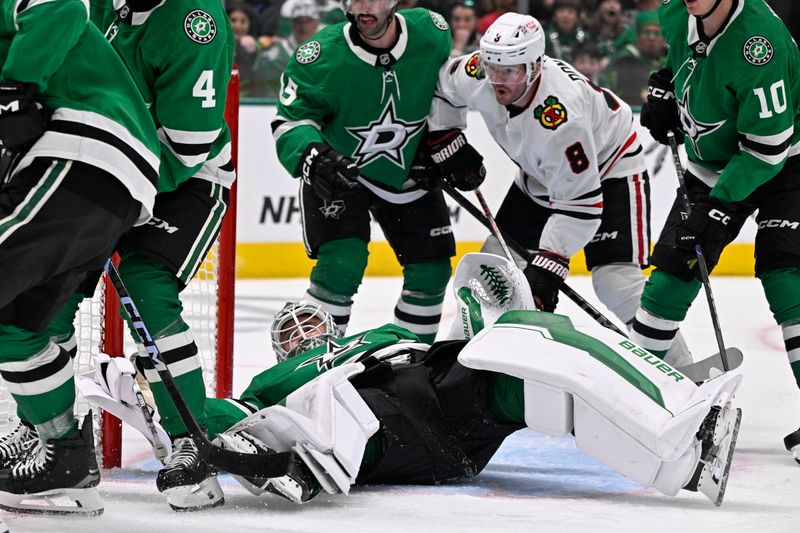 Nov 7, 2024; Dallas, Texas, USA; Dallas Stars goaltender Jake Oettinger (29) covers up the puck as Chicago Blackhawks center Ryan Donato (8) looks for the rebound during the third period at the American Airlines Center. Mandatory Credit: Jerome Miron-Imagn Images