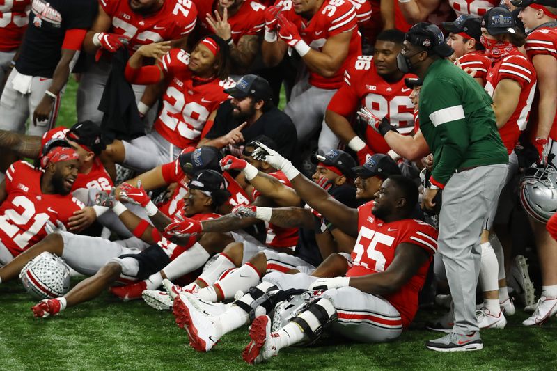 Dec 19, 2020; Indianapolis, Indiana, USA; Members of the Ohio State Buckeyes celebrate after defeating the Northwestern Wildcats at Lucas Oil Stadium. Mandatory Credit: Aaron Doster-USA TODAY Sports