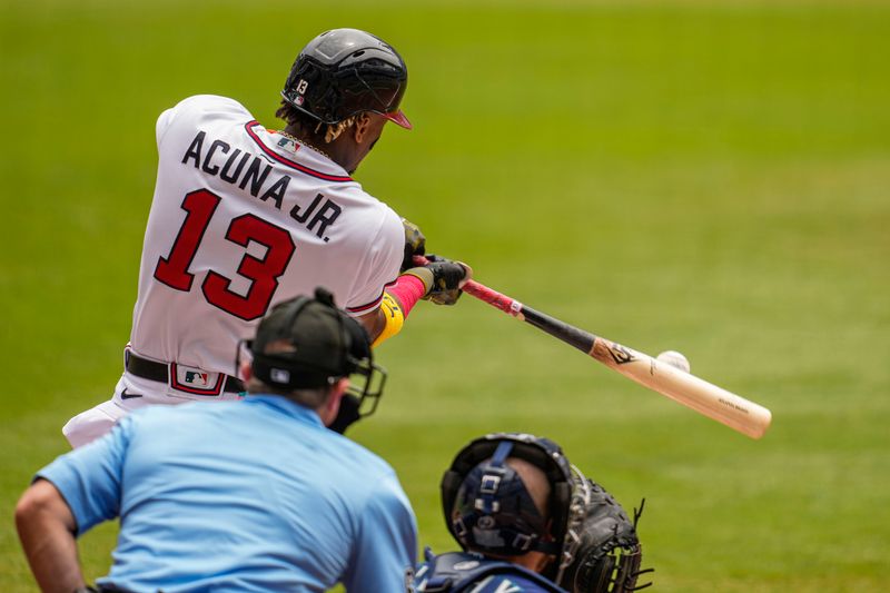 May 21, 2023; Cumberland, Georgia, USA; Atlanta Braves right fielder Ronald Acuna Jr. (13) singles against the Seattle Mariners during the first inning at Truist Park. Mandatory Credit: Dale Zanine-USA TODAY Sports